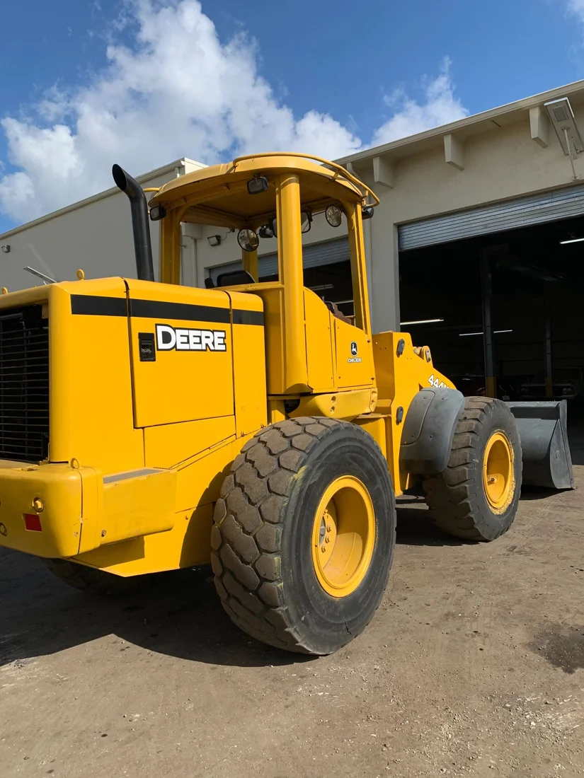 Yellow John Deere loader outside the workshop, from A-1’s existing website